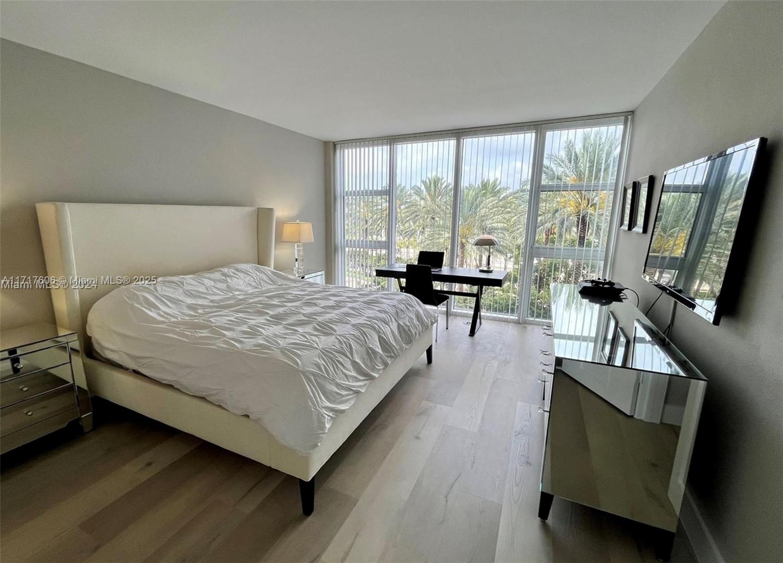 10275 Collins Avenue, Unit 331 Bal Harbour, FL 33154 - Photo 10 of 15 a spacious bedroom with a bed and large windows