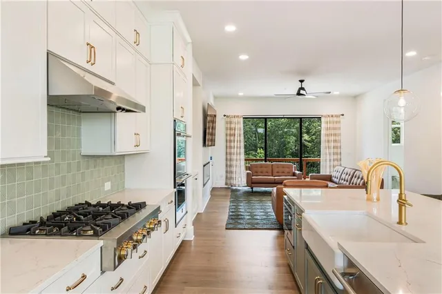 a view of a hallway with wooden floor and entryway