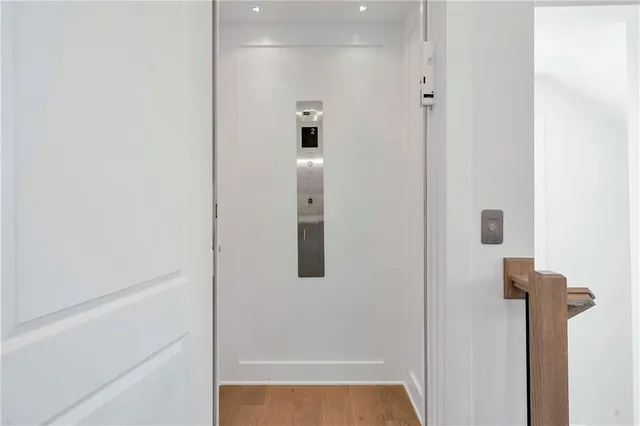 a view of a room with wooden floor