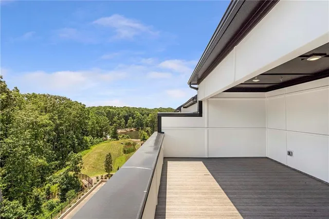 a view of a hallway with stairs and wooden floor