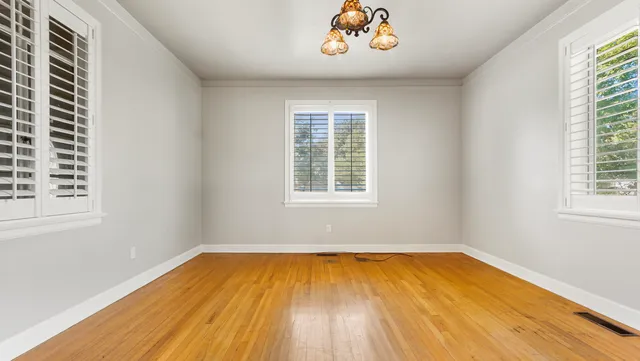 wooden floor in a room next to a window