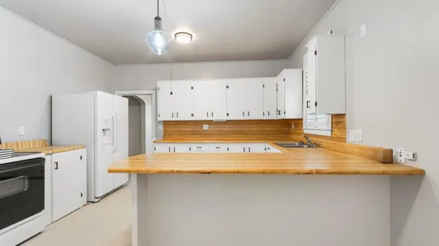 a view of a kitchen with appliances