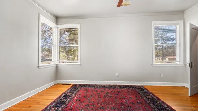 a view of a room with window and wooden floor