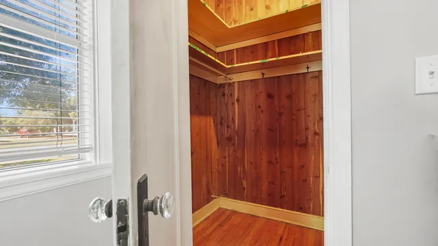 a view of a room with wooden floor and windows