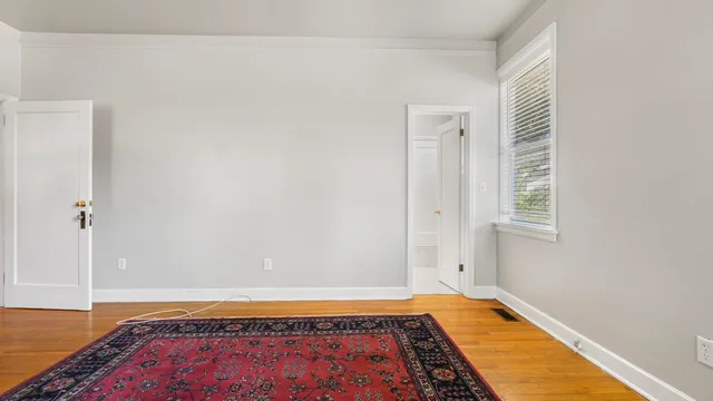 a view of a room with wooden floor and cabinet