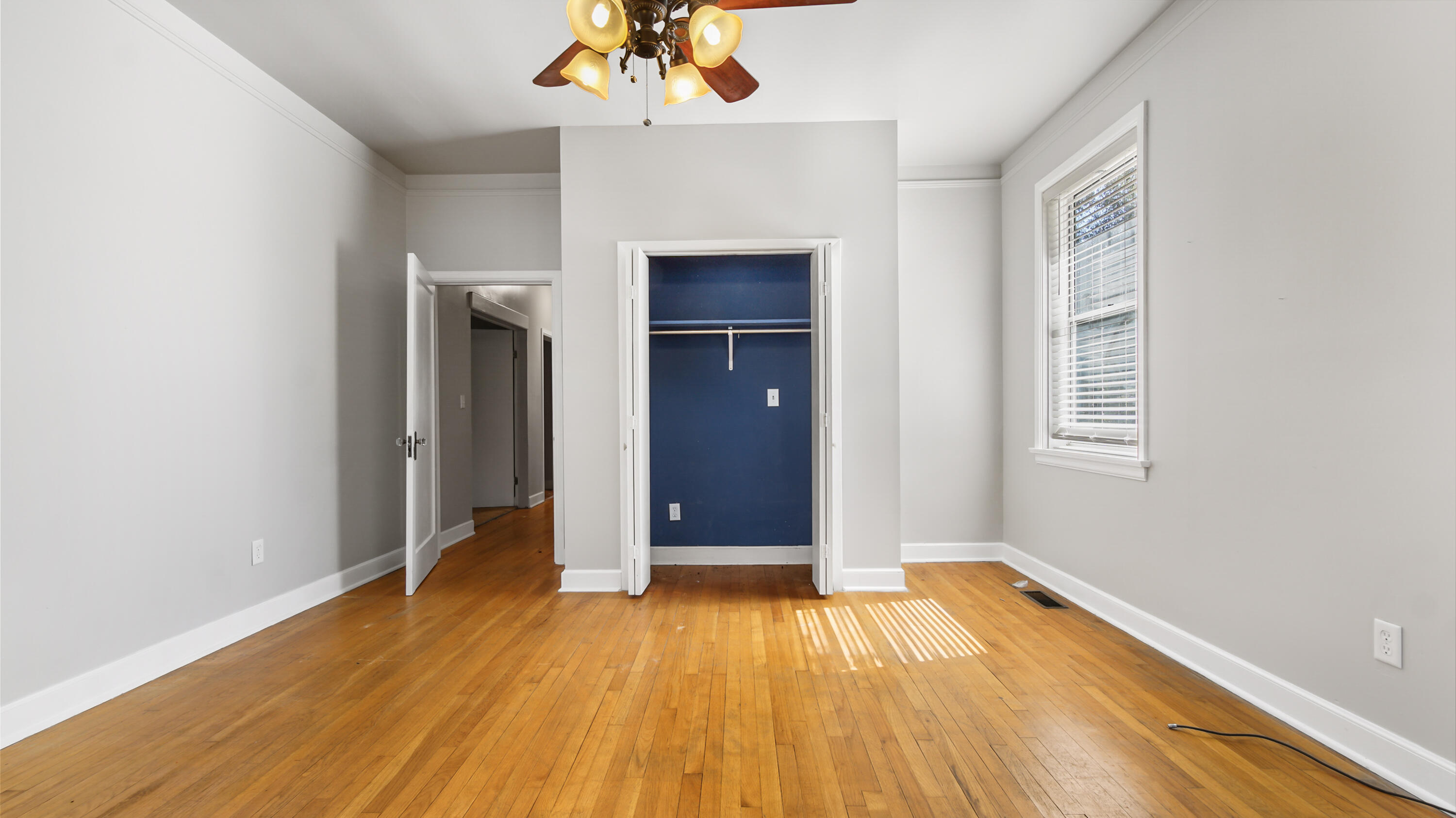 111 Bay Avenue DeFuniak Springs, FL 32435 - Photo 29 of 51 an empty room with wooden floor and windows