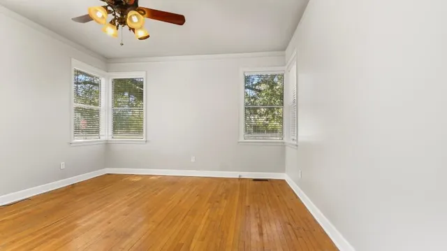 wooden floor in an empty room with a window