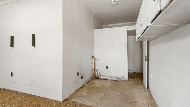 a view of walk in closet with white walls