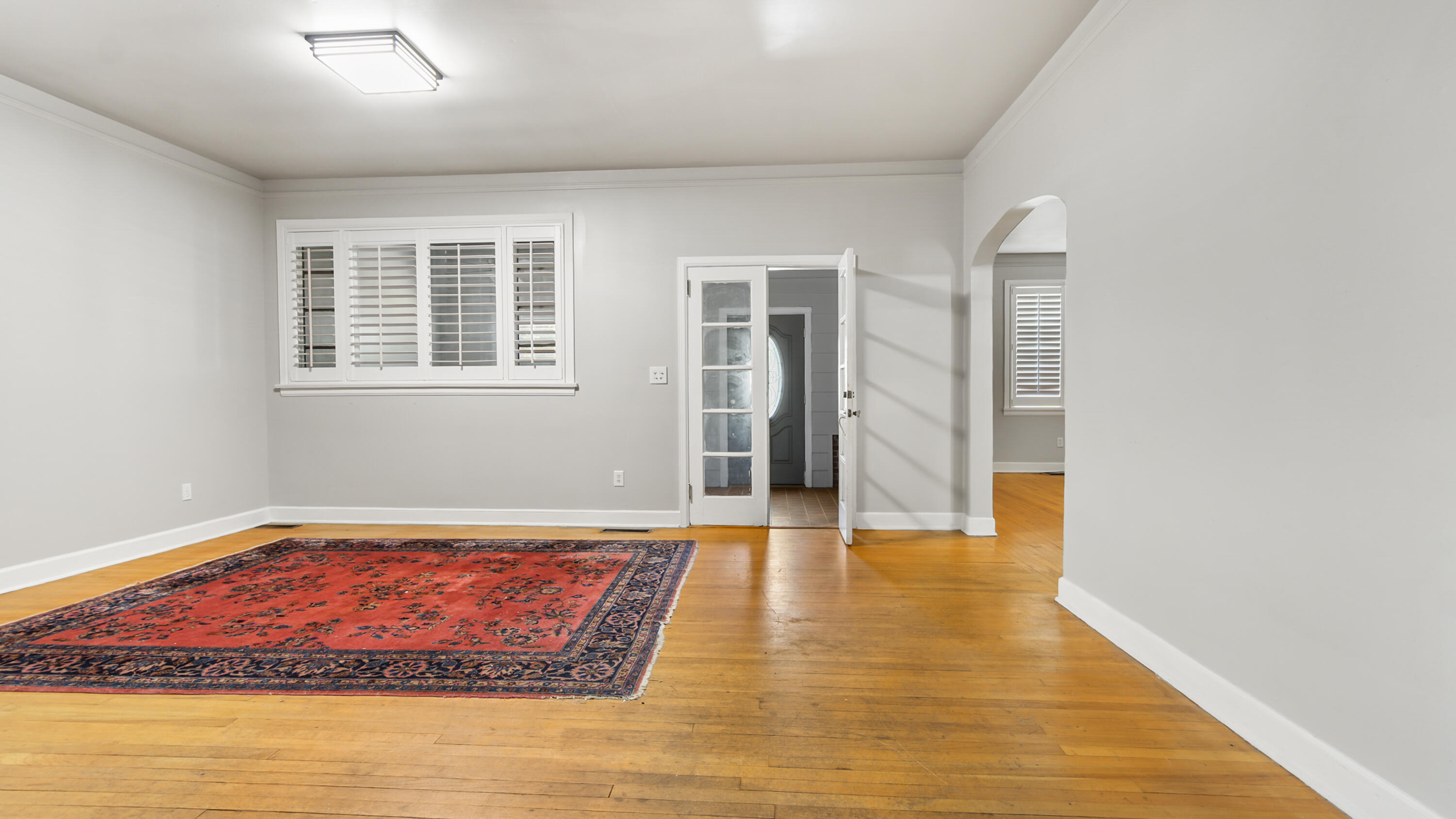111 Bay Avenue DeFuniak Springs, FL 32435 - Photo 9 of 51 a view of an empty room with wooden floor and a window