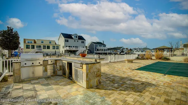 a living room with lots of furniture and a kitchen view