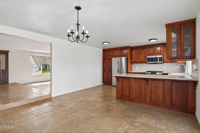 a view of a kitchen with a sink and cabinets