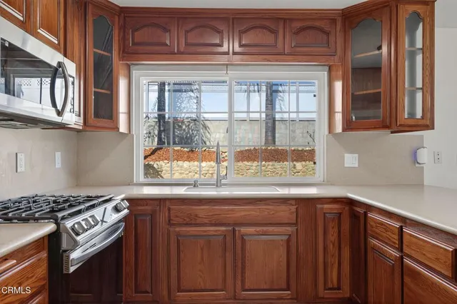 a kitchen with granite countertop a stove and cabinets