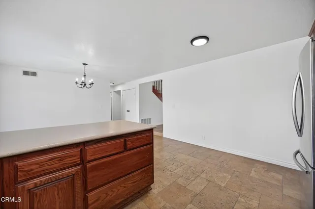 a view of room and kitchen