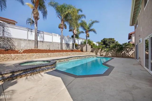 a backyard of a house with a yard and outdoor seating