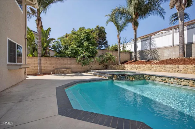 a swimming pool with outdoor seating and yard