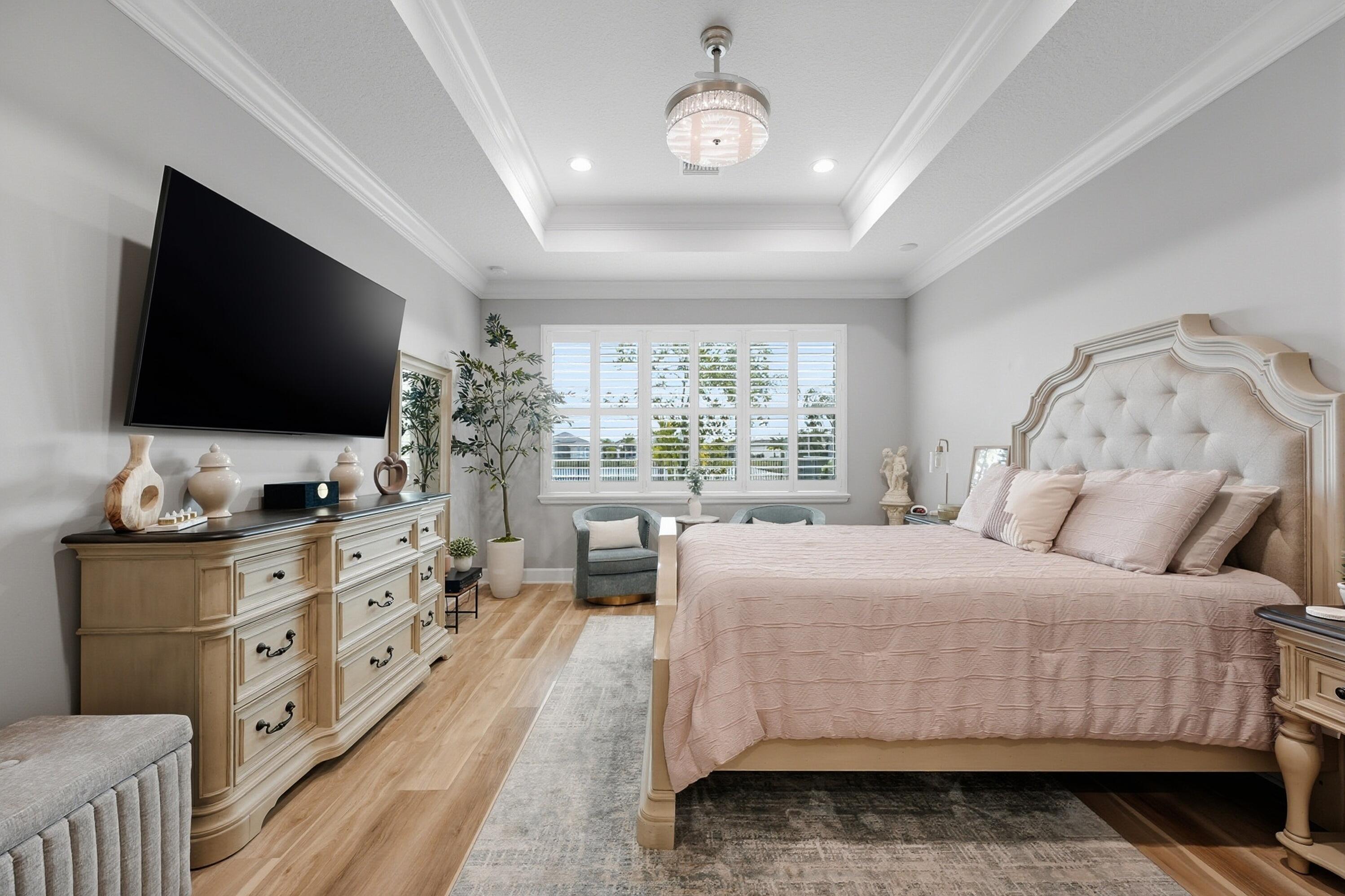 11784 Southwest Sailfish Isles Way Port St. Lucie, FL 34987 - Photo 18 of 77 a bedroom with a large bed and a flat screen tv on the dresser