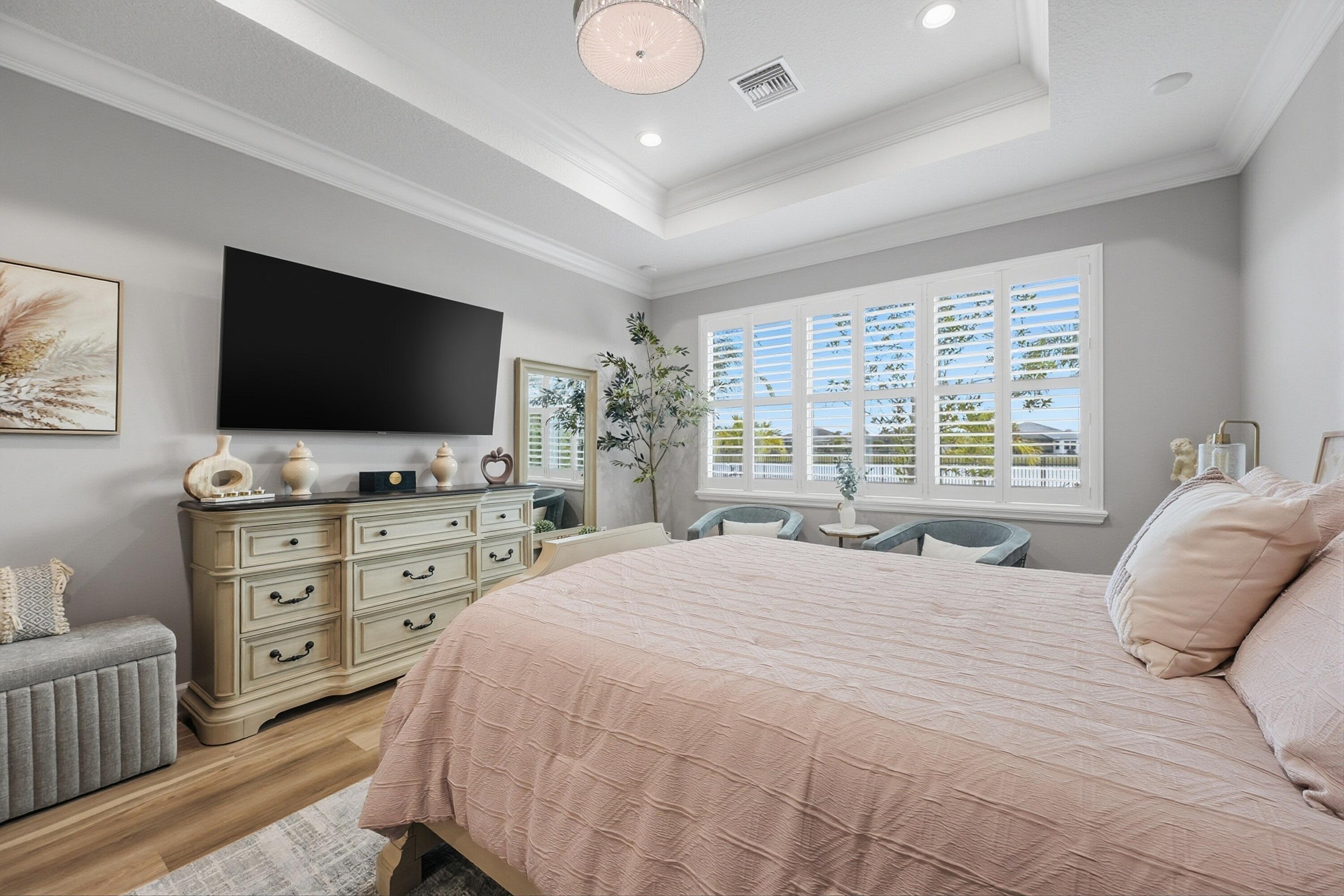 11784 Southwest Sailfish Isles Way Port St. Lucie, FL 34987 - Photo 19 of 77 a bedroom with a bed and a flat screen tv on dresser