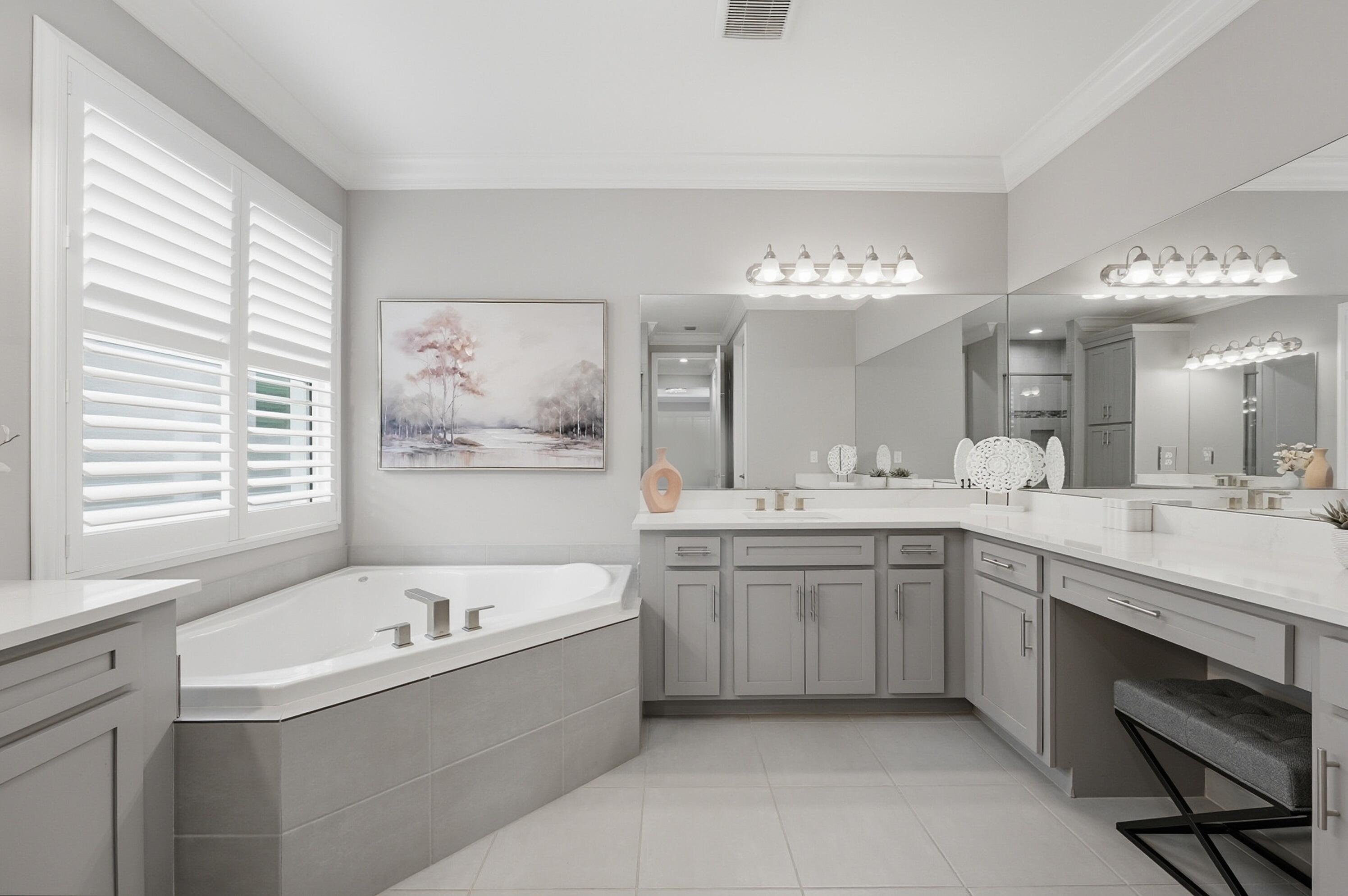 11784 Southwest Sailfish Isles Way Port St. Lucie, FL 34987 - Photo 20 of 77 a large bathroom with a large tub sink and large mirror