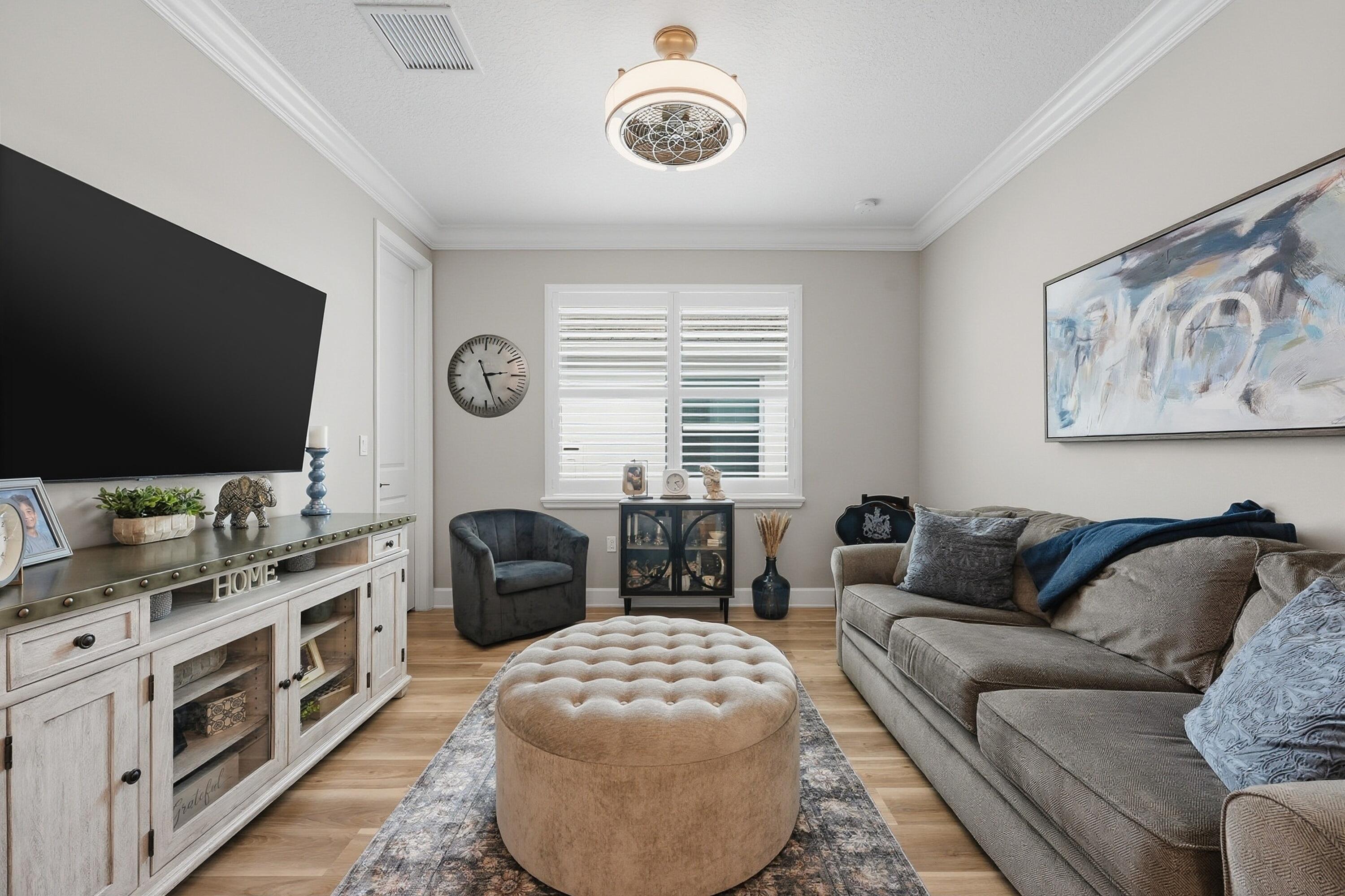 11784 Southwest Sailfish Isles Way Port St. Lucie, FL 34987 - Photo 22 of 77 a living room with furniture and a flat screen tv