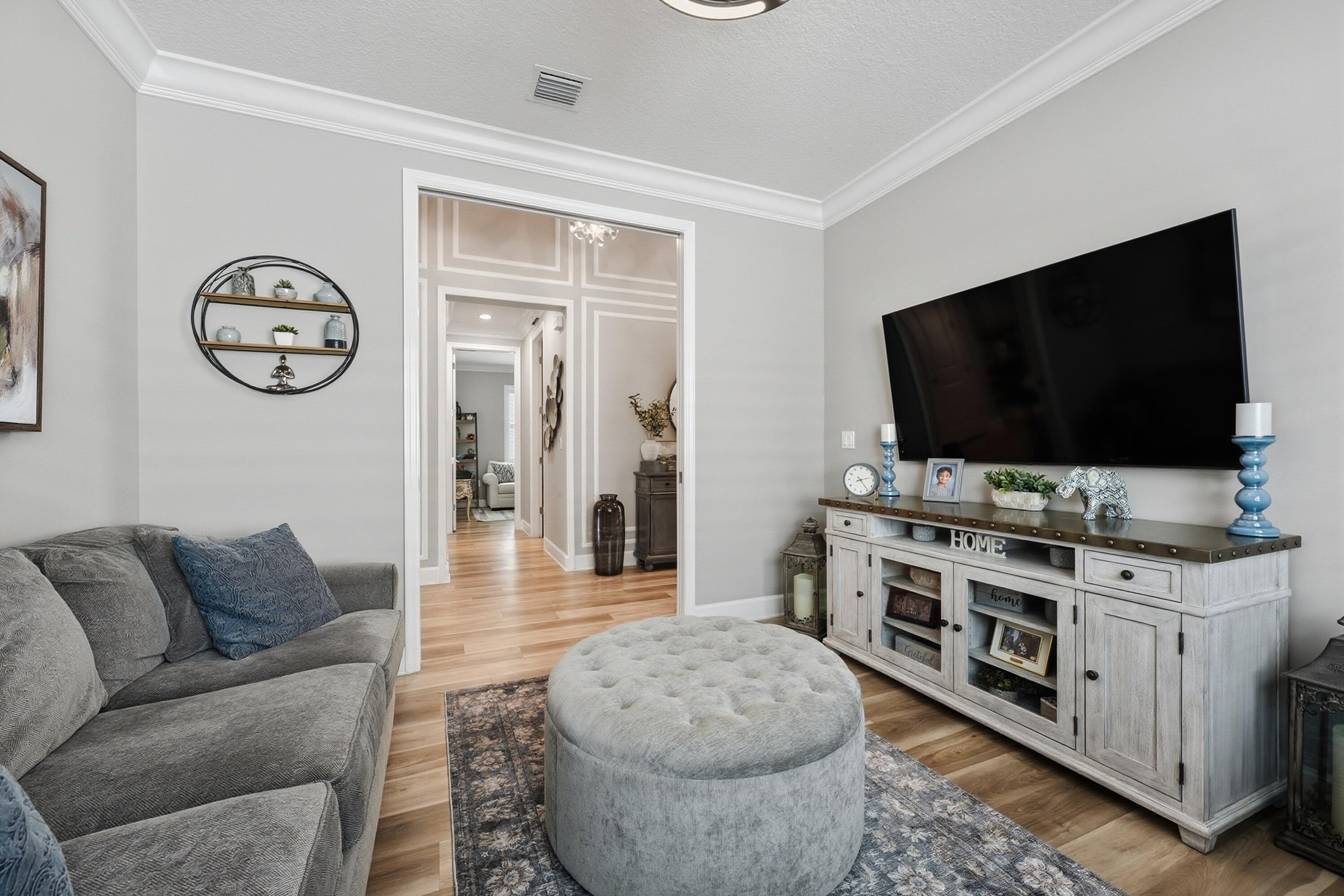 11784 Southwest Sailfish Isles Way Port St. Lucie, FL 34987 - Photo 23 of 77 a living room with furniture and a flat screen tv