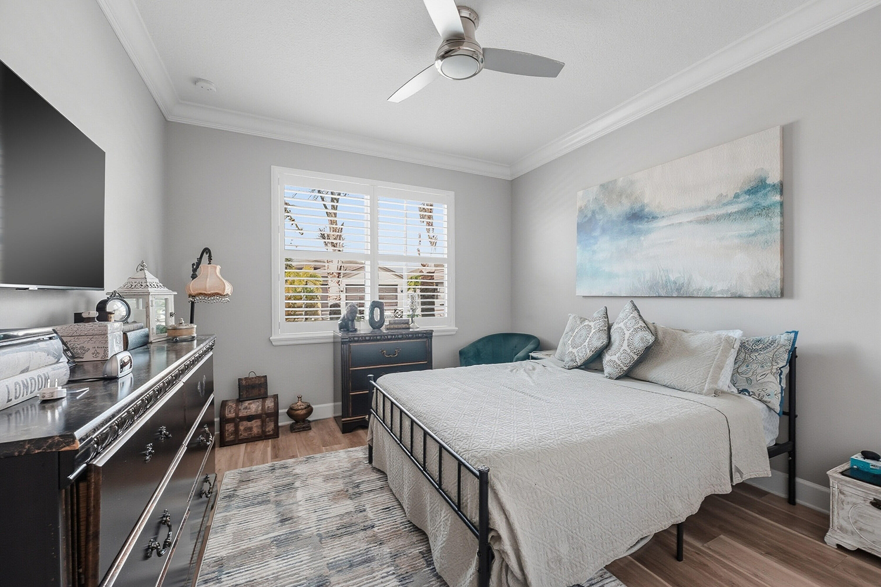 11784 Southwest Sailfish Isles Way Port St. Lucie, FL 34987 - Photo 24 of 77 a bedroom with a bed and a flat tv screen on dresser