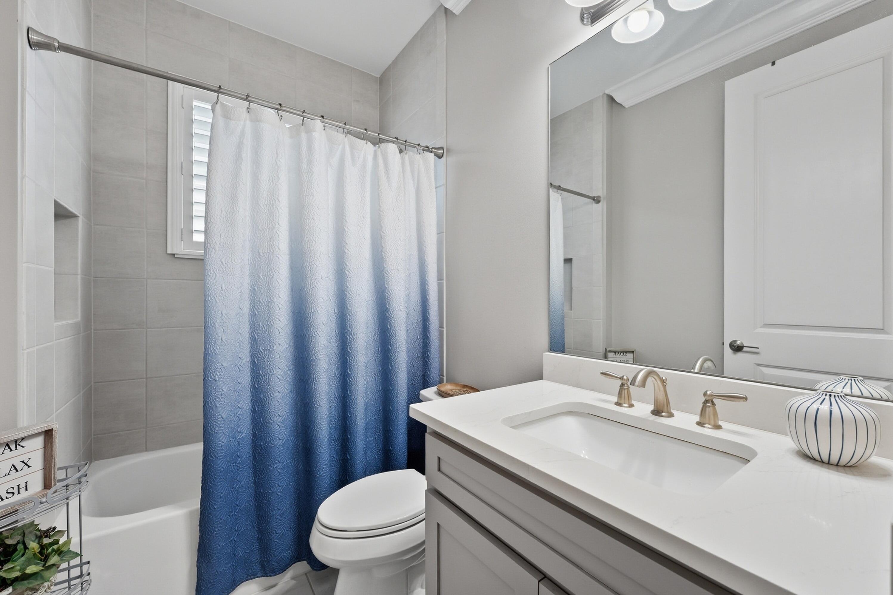 11784 Southwest Sailfish Isles Way Port St. Lucie, FL 34987 - Photo 25 of 77 a bathroom with a granite countertop sink toilet and shower