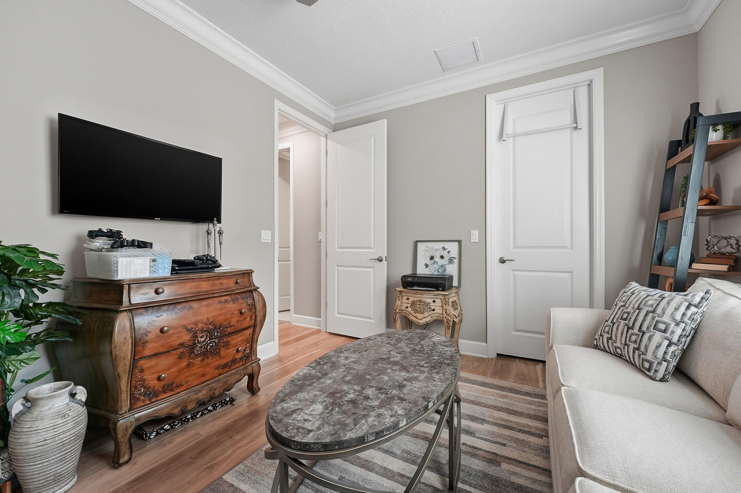 11784 Southwest Sailfish Isles Way Port St. Lucie, FL 34987 - Photo 27 of 77 a living room with furniture and a flat screen tv