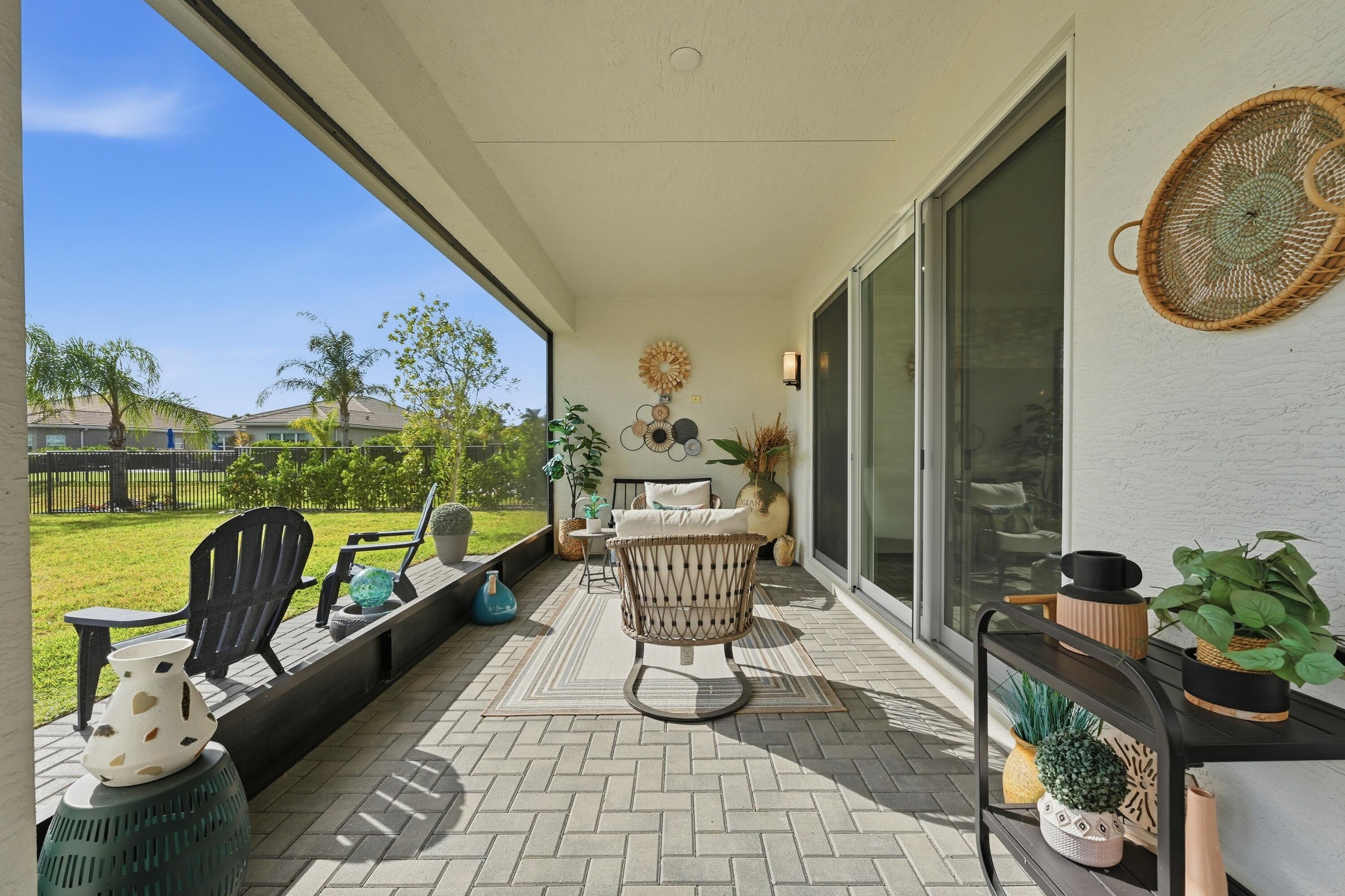 11784 Southwest Sailfish Isles Way Port St. Lucie, FL 34987 - Photo 31 of 77 a view of a chairs and table in the balcony