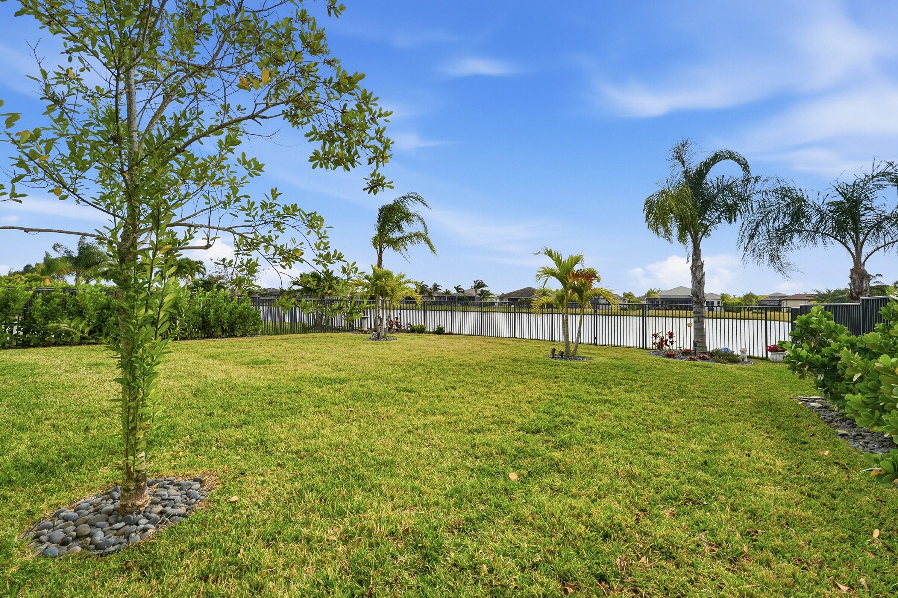 11784 Southwest Sailfish Isles Way Port St. Lucie, FL 34987 - Photo 34 of 77 a view of a golf course with a lake