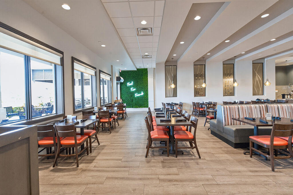 11784 Southwest Sailfish Isles Way Port St. Lucie, FL 34987 - Photo 47 of 77 a living room with furniture and large windows