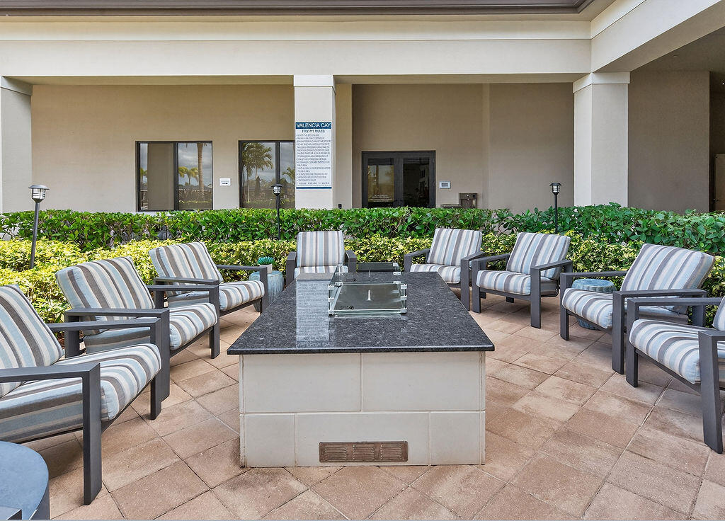 11784 Southwest Sailfish Isles Way Port St. Lucie, FL 34987 - Photo 49 of 77 a view of a patio with couches table and chairs and potted plants