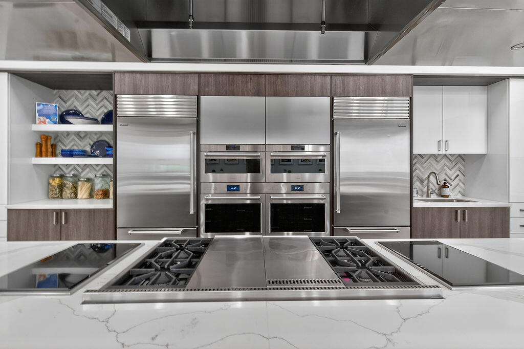 11784 Southwest Sailfish Isles Way Port St. Lucie, FL 34987 - Photo 52 of 77 a kitchen with a stove a refrigerator and cabinets