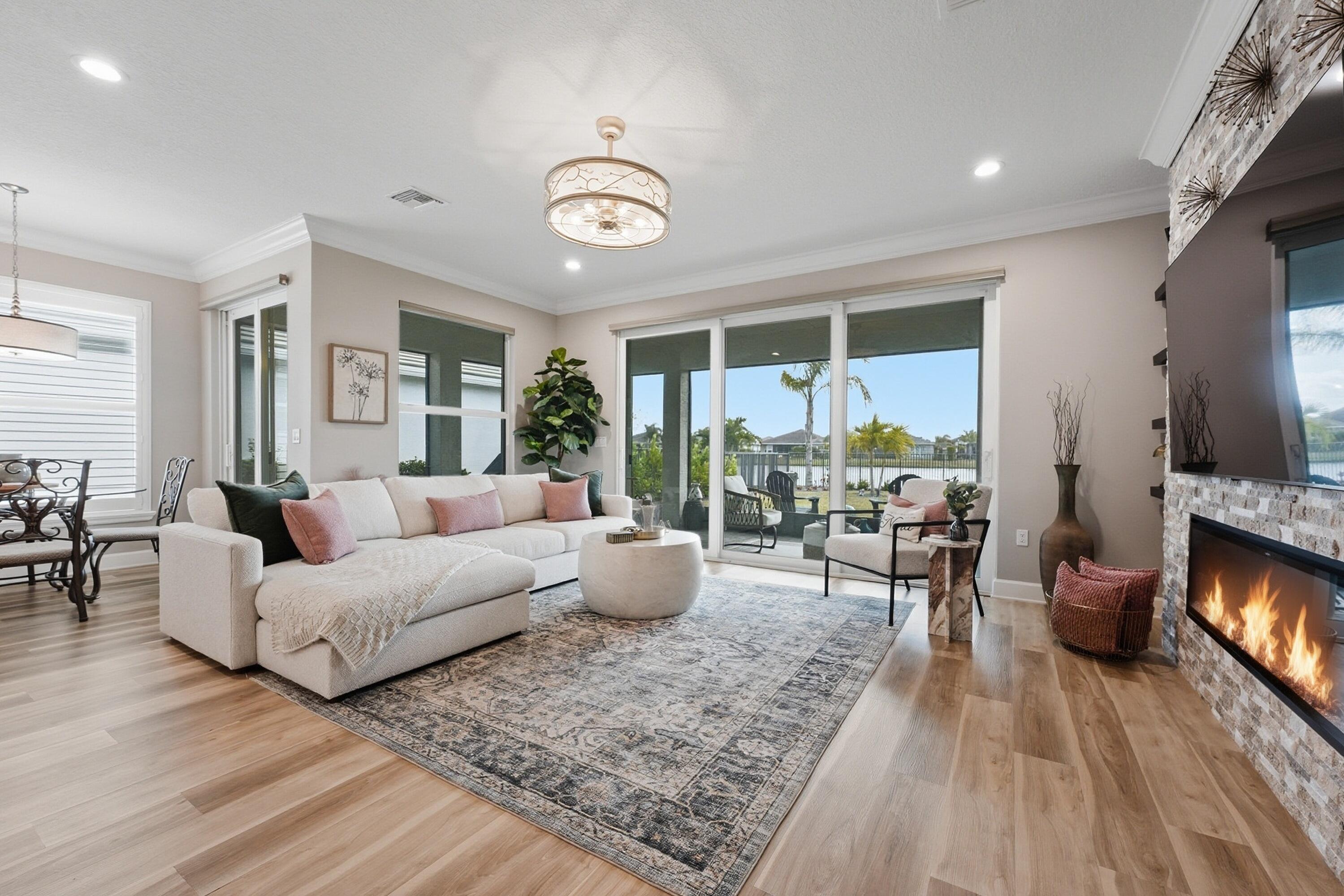11784 Southwest Sailfish Isles Way Port St. Lucie, FL 34987 - Photo 10 of 77 a living room with furniture wooden floor and a large window