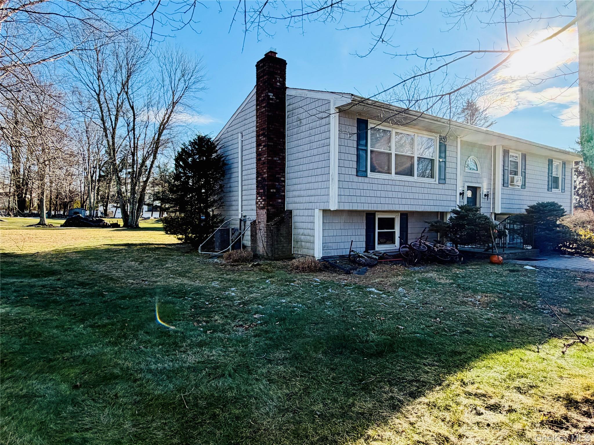 110 Wayacross Road Mahopac, NY 10541 - Photo 3 of 18 View of side of property featuring a lawn and a chimney