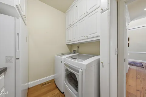 a bathroom with a sink a washer and dryer
