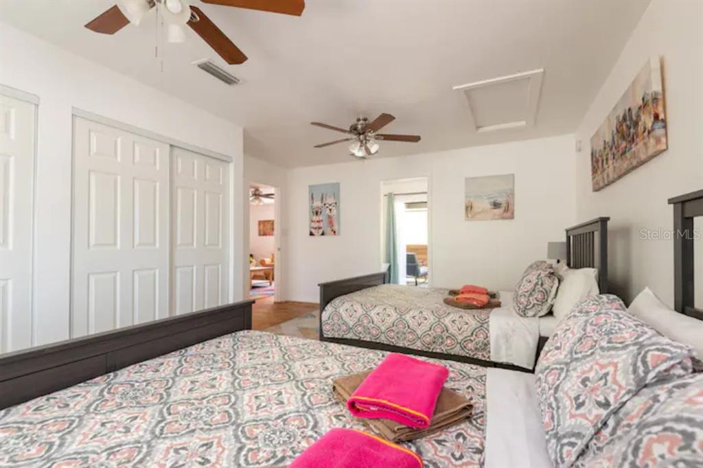 368 Ridge Road Southwest Largo, FL 33770 - Photo 15 of 46 a bedroom with a large bed and a chandelier