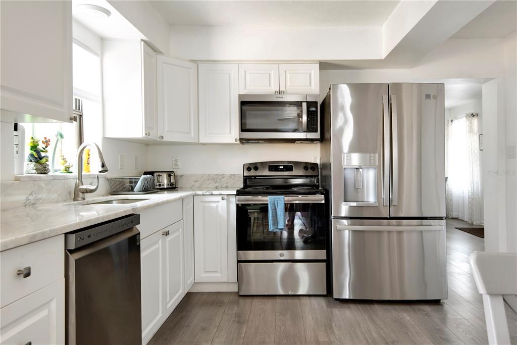 368 Ridge Road Southwest Largo, FL 33770 - Photo 29 of 46 a kitchen with a sink and steel stainless steel appliances