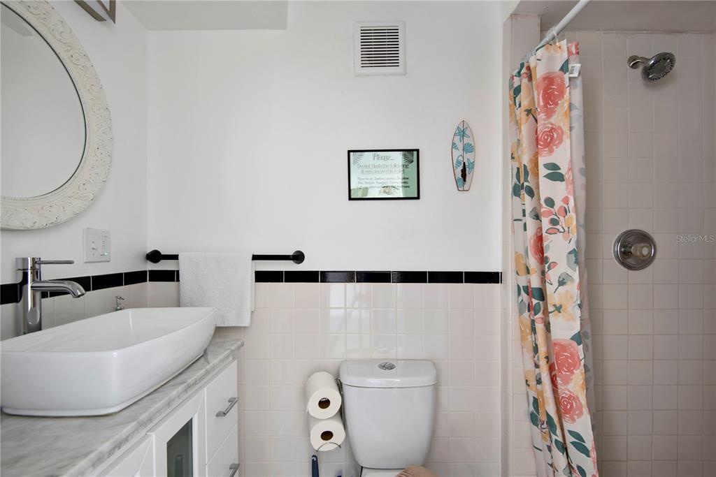 368 Ridge Road Southwest Largo, FL 33770 - Photo 43 of 46 a bathroom with a sink a toilet and a mirror