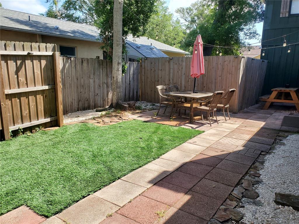 368 Ridge Road Southwest Largo, FL 33770 - Photo 45 of 46 a view of backyard with wooden fence and a bench