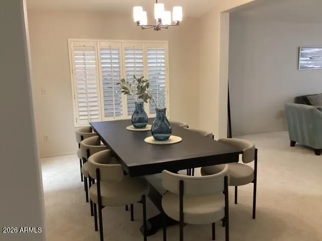 a kitchen with stainless steel appliances granite countertop a sink a stove a microwave a refrigerator and white cabinets