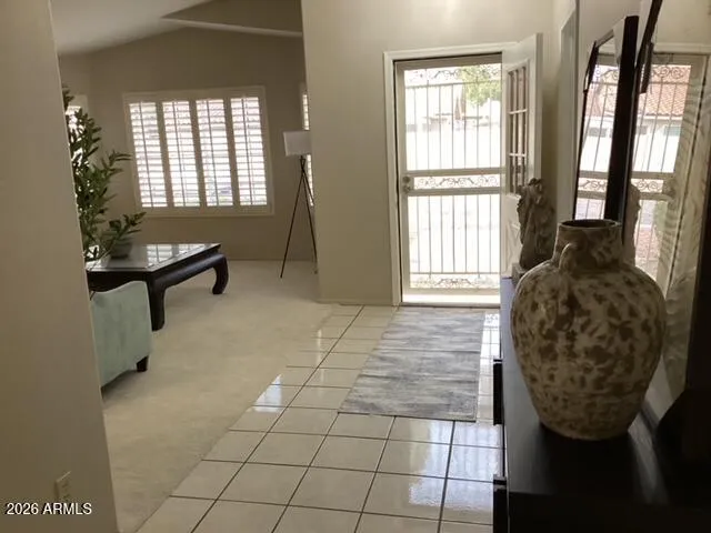 a living room with furniture and a potted plant
