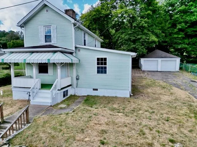 a house that has a tree in front of it