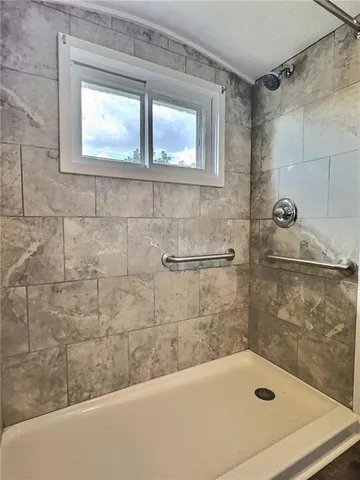 a bathroom with a tub and shower