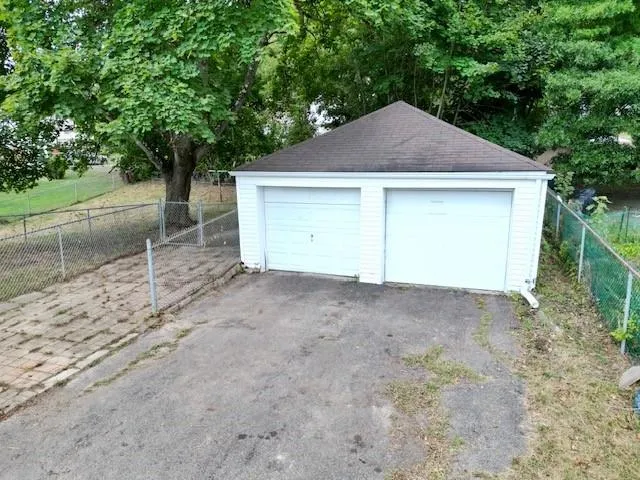 a view of a house with a yard and garage
