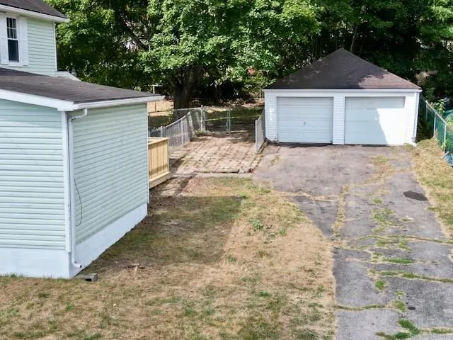 a view of a small house with a yard