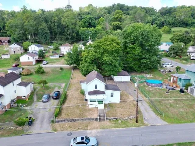 an aerial view of house with yard swimming pool and outdoor seating