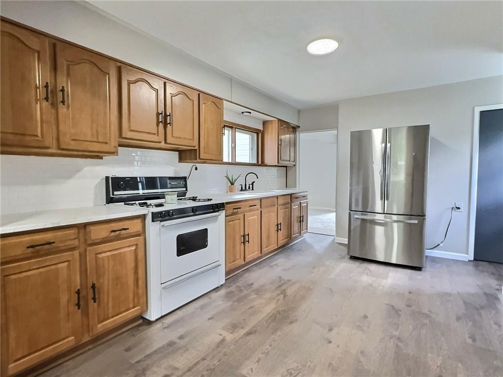 91 Blanche Road Fredericktown, PA 15333 - Photo 10 of 41 a kitchen with stainless steel appliances granite countertop a stove a refrigerator and a cabinets