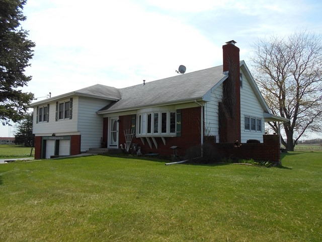 a view of house with a yard