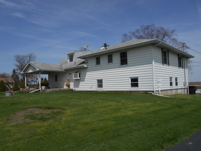 1598 North Ridge Road Mount Morris, IL 61054 - Photo 2 of 19 a front view of a house with a garden