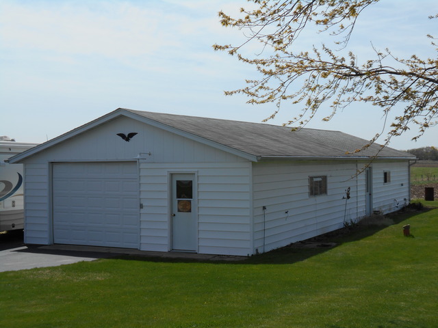 1598 North Ridge Road Mount Morris, IL 61054 - Photo 3 of 19 a view of a backyard with plants and large tree